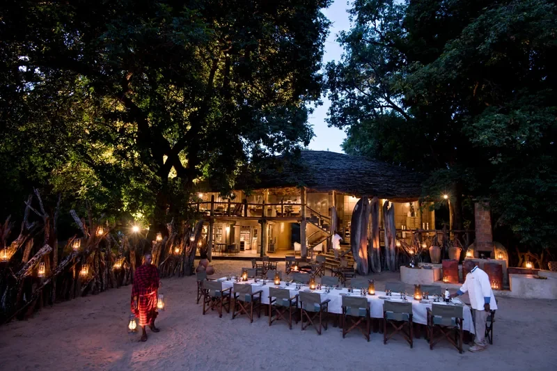 Lake Manyara Tree Lodge, Tanzania – lantern‑lit boma courtyard set for dinner under ancient trees