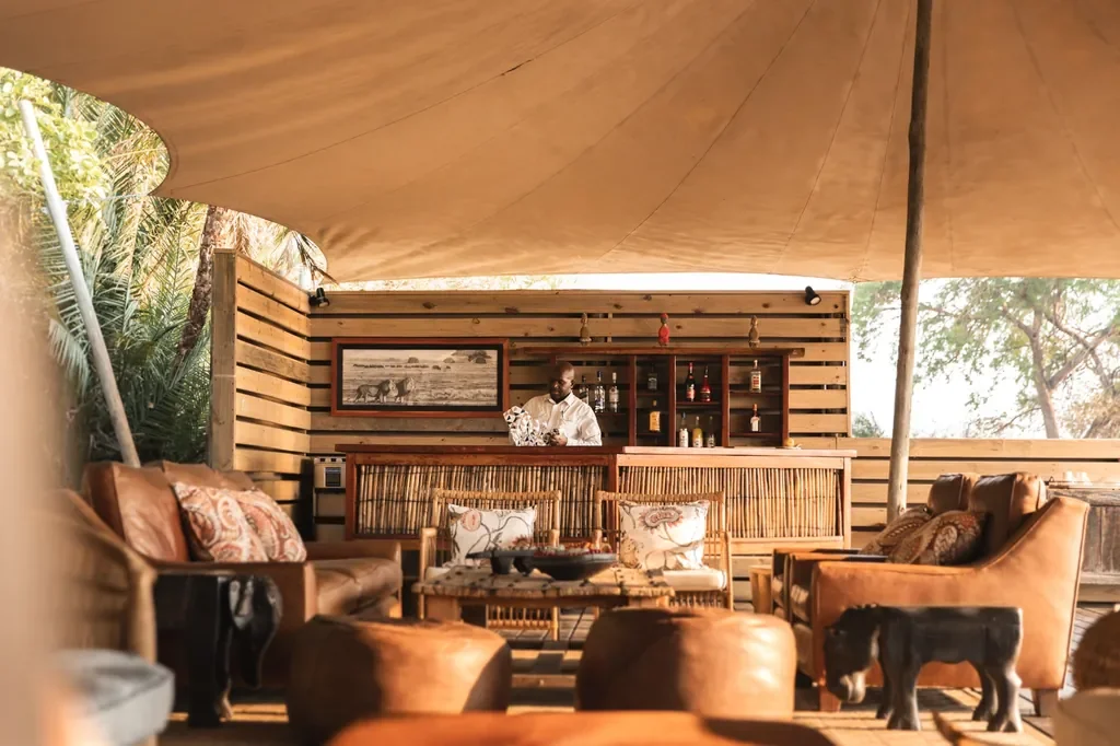 Camp bar and leather lounge seating beneath stretch canvas, Busanga Bush Camp Kafue Zambia