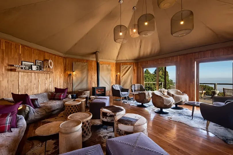 Main lounge at The Highlands with fireplace and crater-facing windows, Ngorongoro