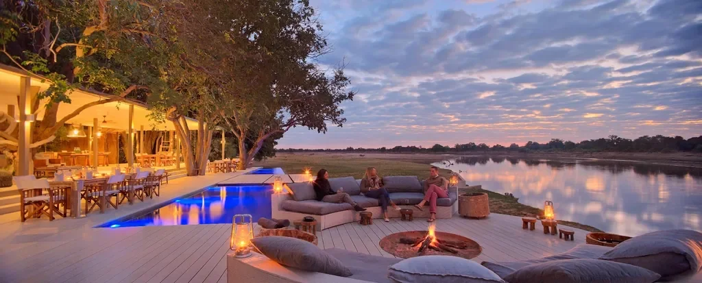 Sunken firepit deck for sundowners at Time + Tide Chinzombo overlooking the Luangwa River, South Luangwa National Park