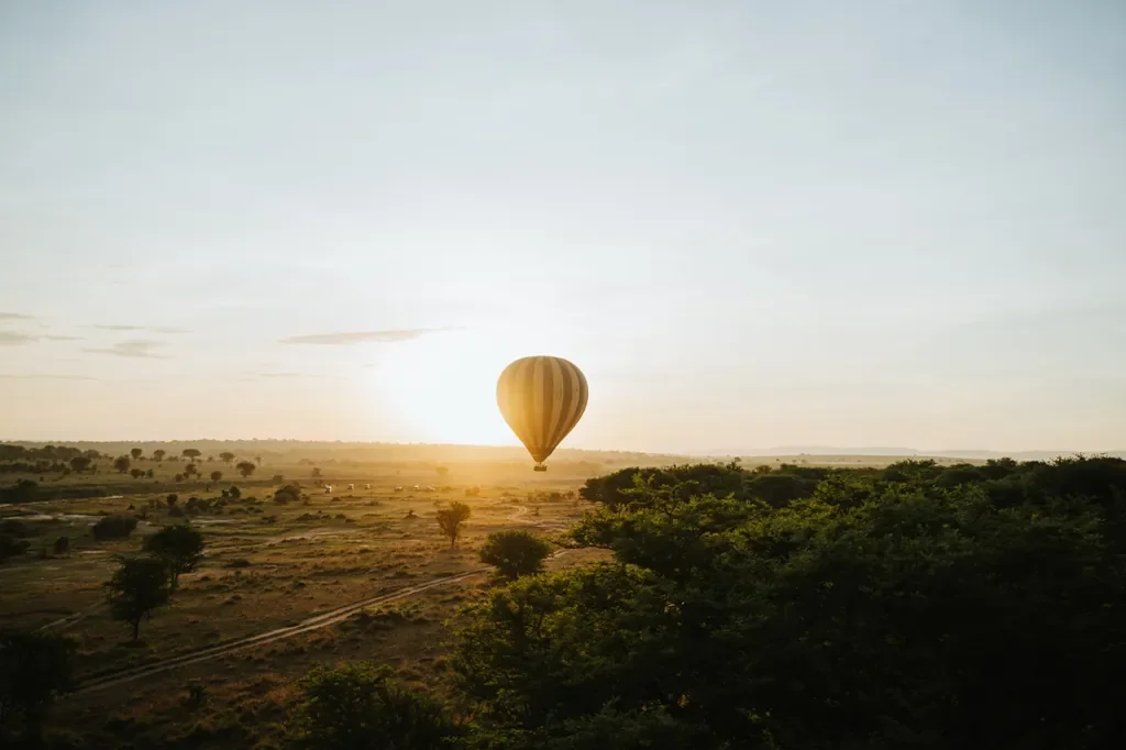 Hot air balloon floating at sunrise over the central Serengeti, activity from Usawa camp