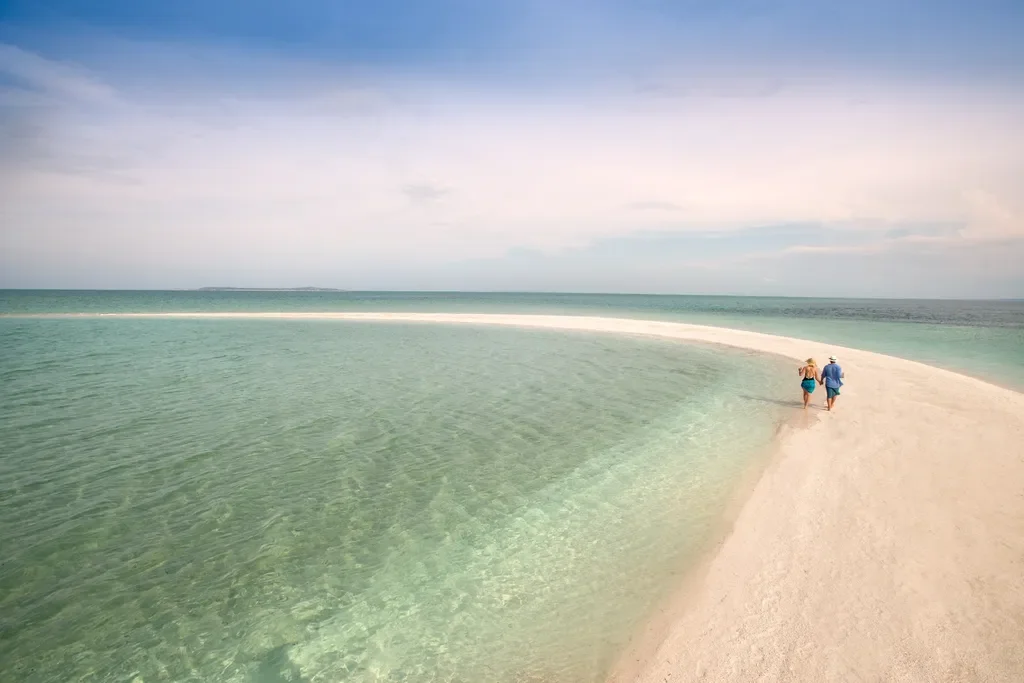 couple walking on the beach at sunset – andBeyond Benguerra Island, Mozambique
