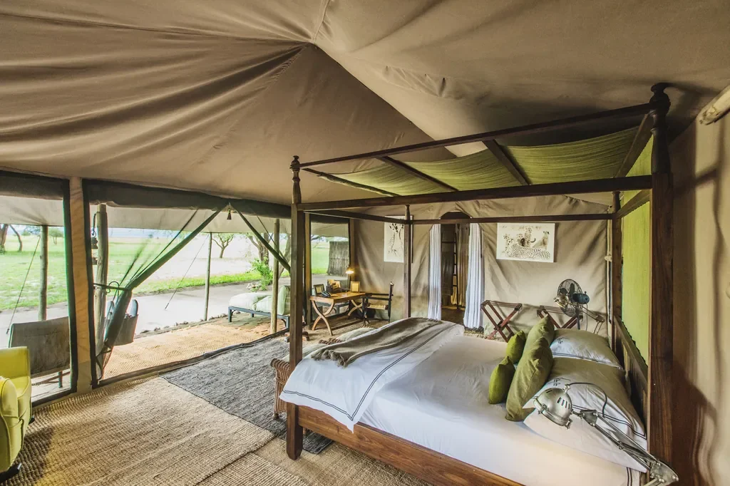Canopy bed in a spacious tented suite at Little Chem Chem, luxury camp near Lake Burunge Tanzania