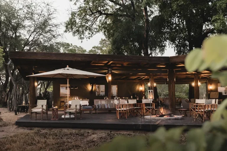 Davison's Camp main deck with firepit and canvas lounge, Hwange National Park Zimbabwe, daytime view