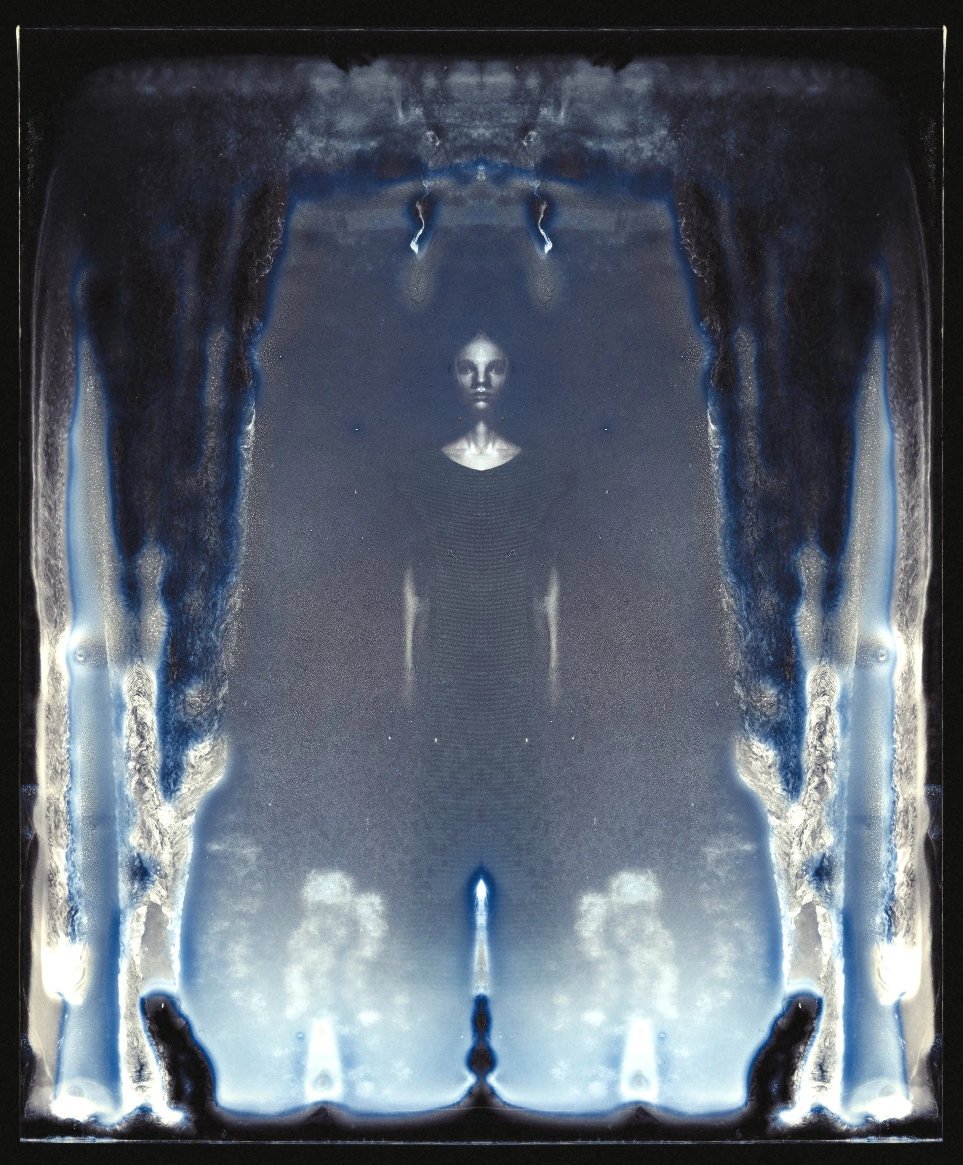 A symmetrical, abstract artwork with a central human-like face and figure surrounded by fluid, smoky patterns in shades of blue, black, and gray.