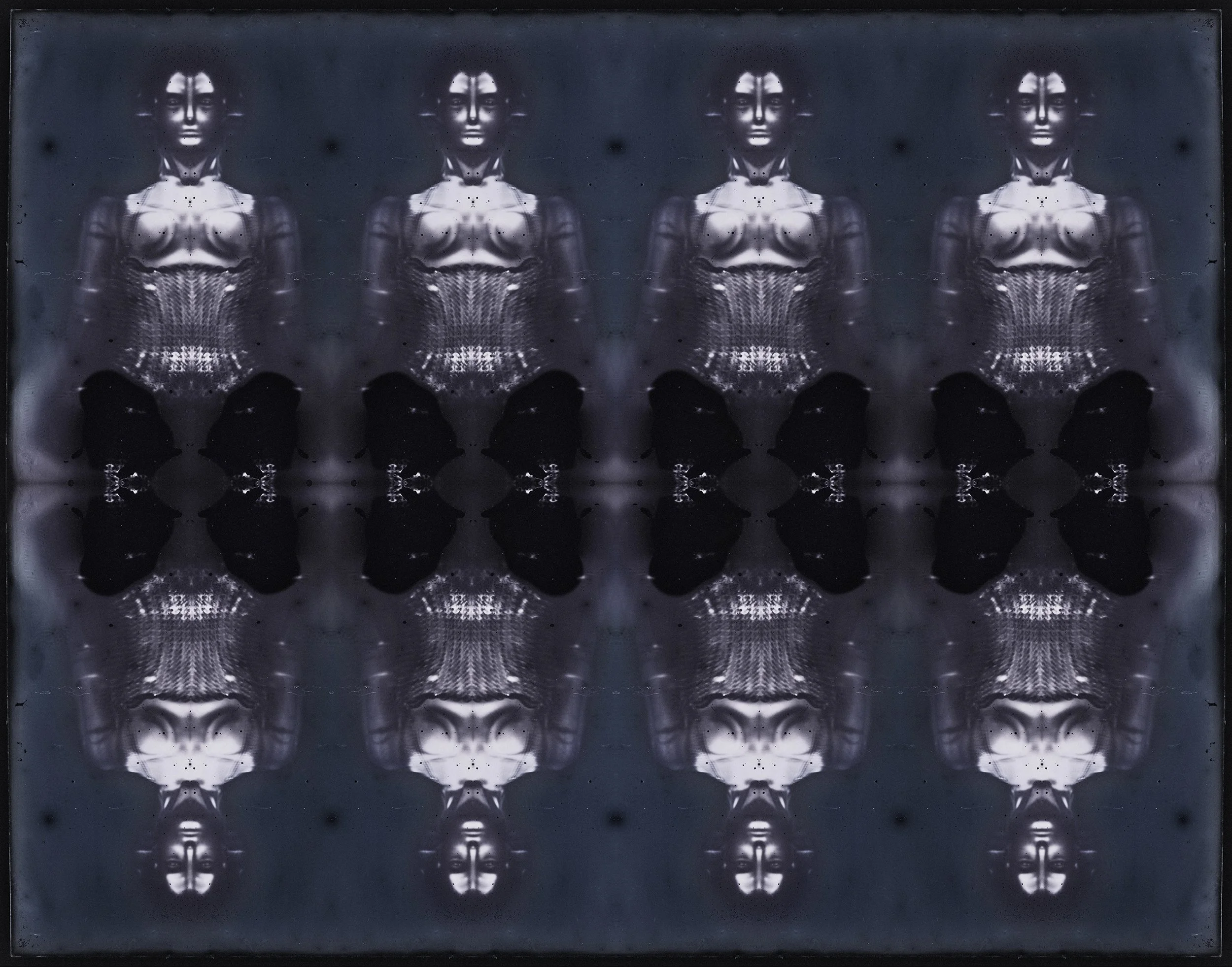 A mirrored, black and white, artistic photo of a woman with shoulder-length hair, dressed in a detailed, corset-style top, with her reflection creating a pattern that resembles a butterfly or skull in the center.