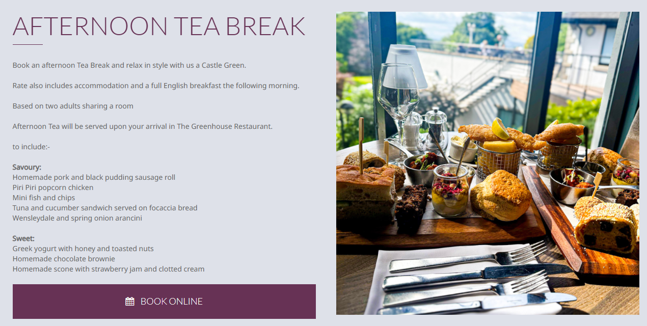 A table set with a variety of sweet and savory finger foods, including slices of cake, bread, pastries, and small bowls of salads, with a view of a green outdoor landscape through large windows.