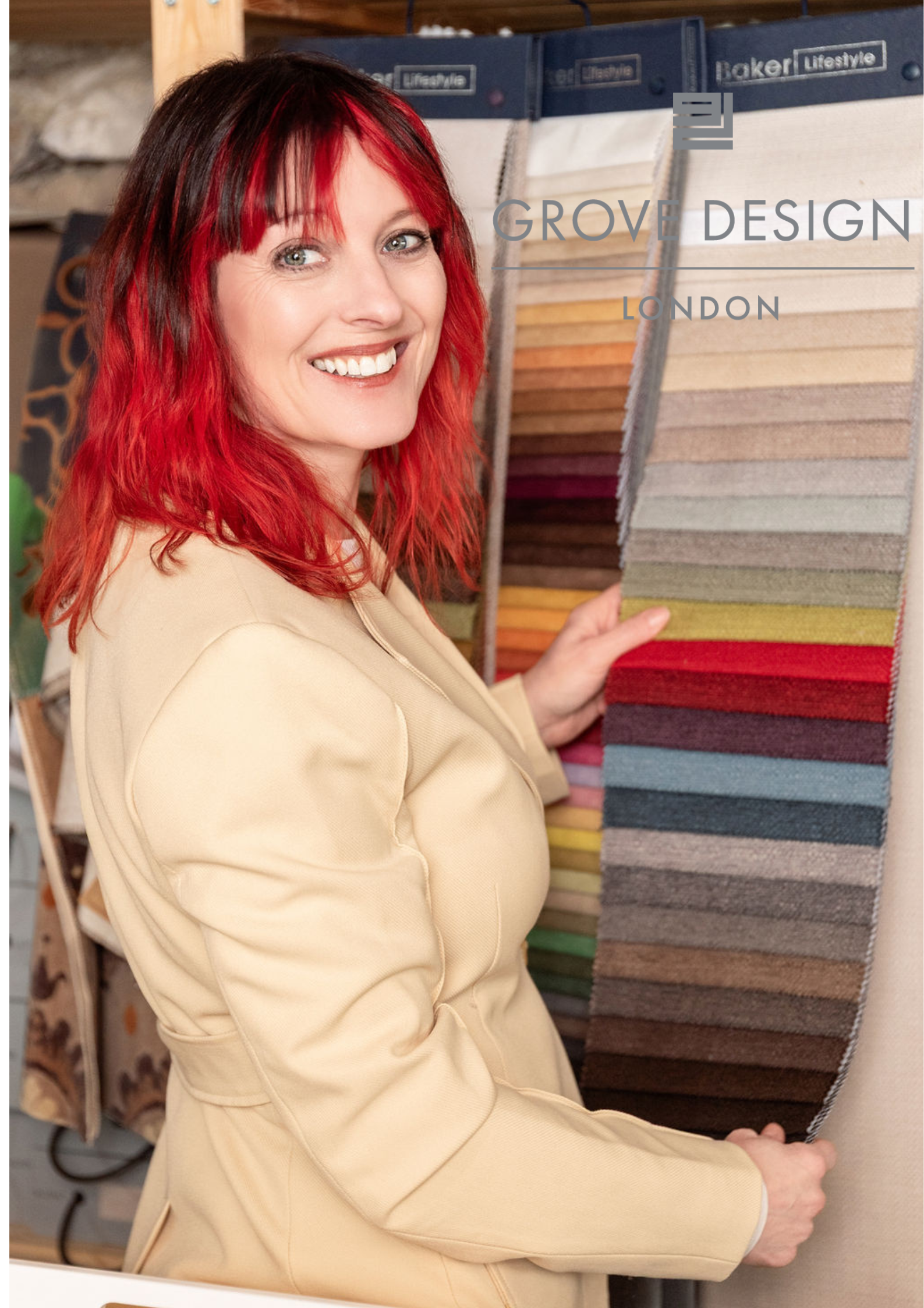 A woman with red hair wearing a beige blazer is standing in front of a display of fabric swatches, smiling and pointing at the fabrics. The background shows fabric samples and a wooden shelf. Text overlay reads 'Grove Design London'.