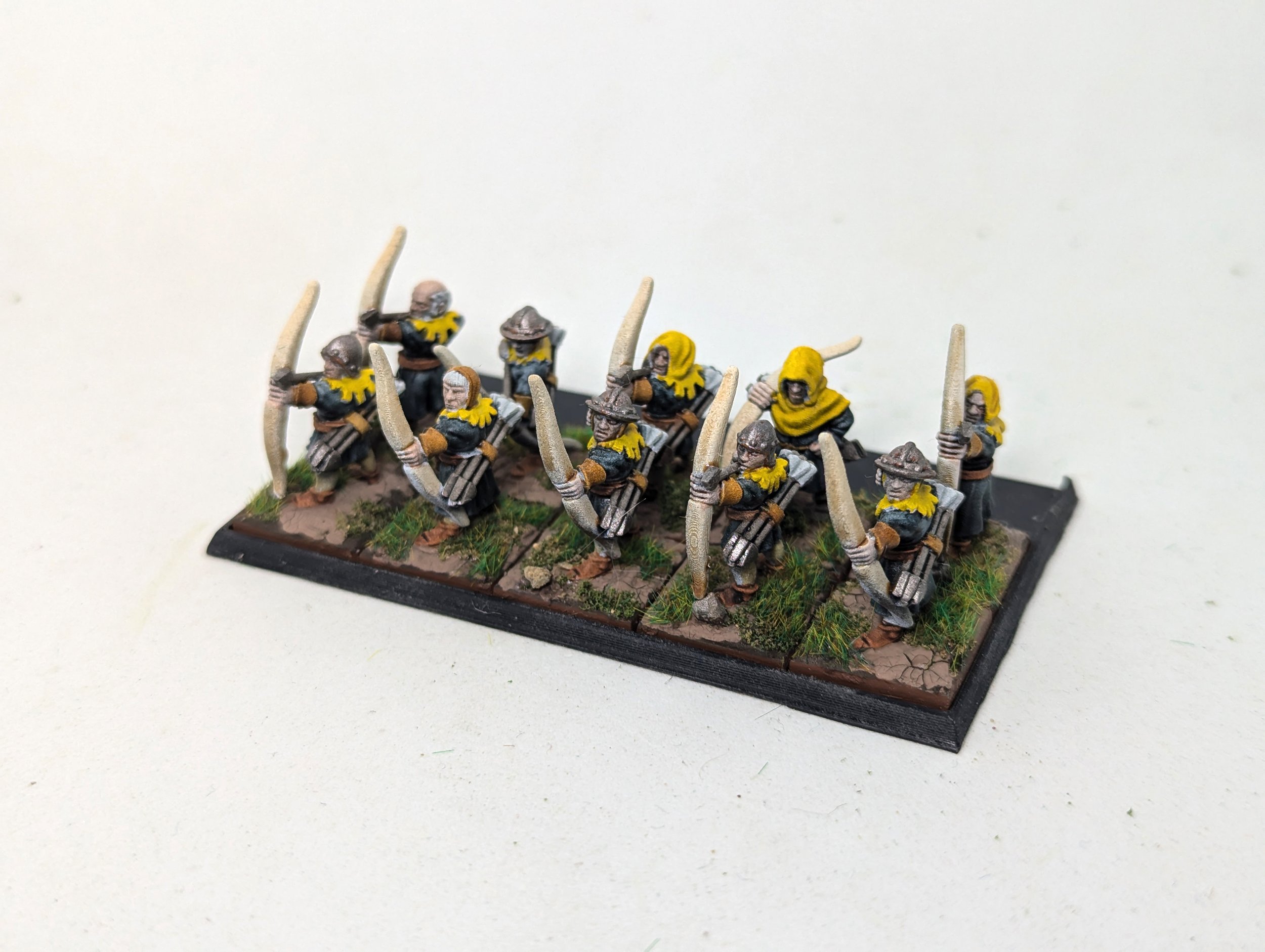 15mm fantasy archers in yellow-and-black uniforms on individual square bases.15mm fantasy archers in yellow-and-black uniforms on individual square bases.