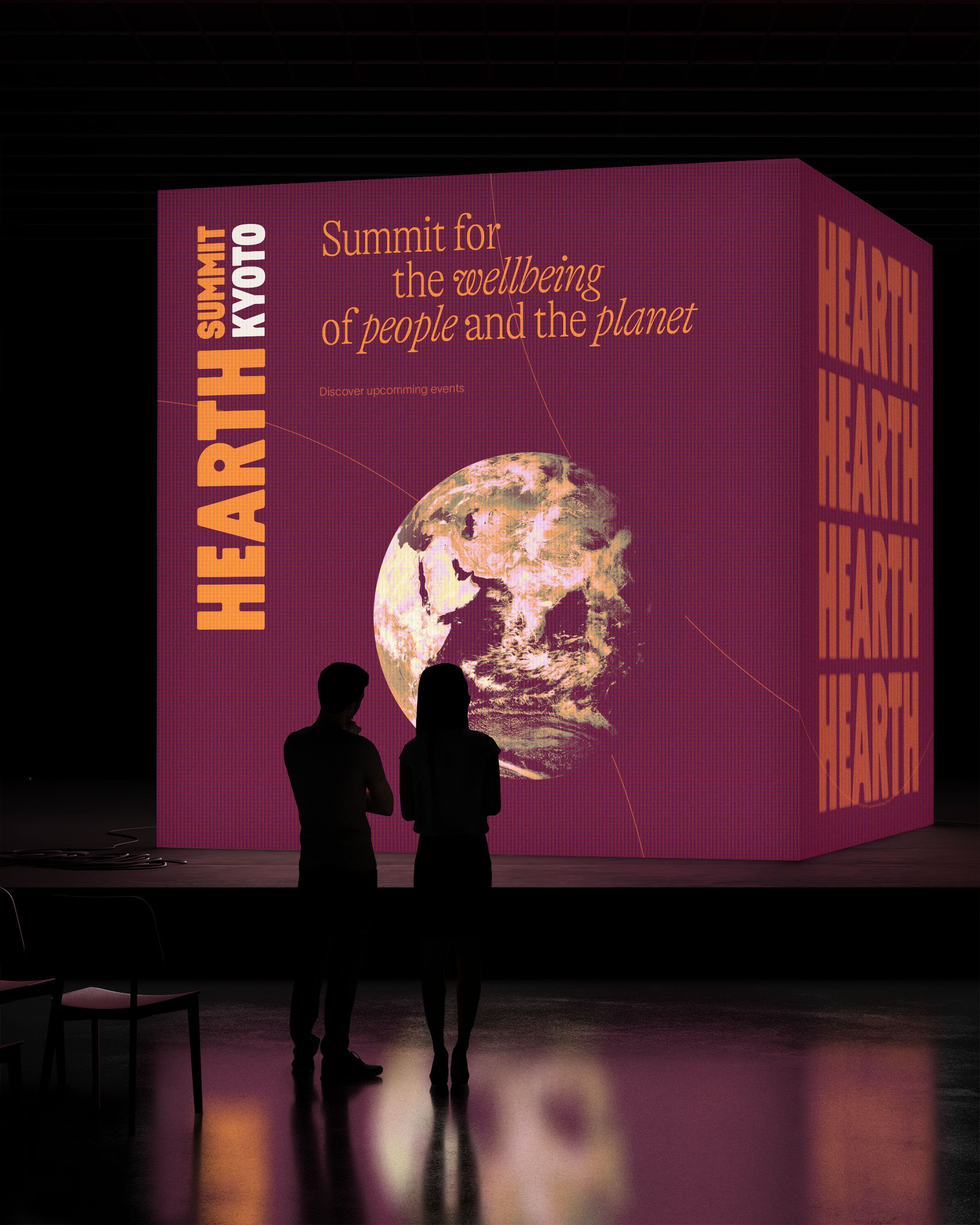 Deux personnes regardent un grand écran affichant un message sur la durabilité de la planète, avec une image de la Terre et le texte 'Summit for the wellbeing of people and the planet'.