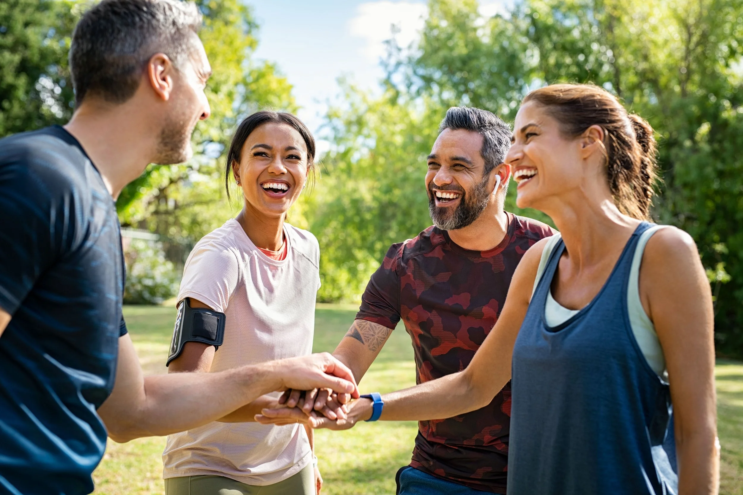 Group-of-active-mature-friends-in-park-stacking-hands-after-workout-1319764588_6192x4128.jpg