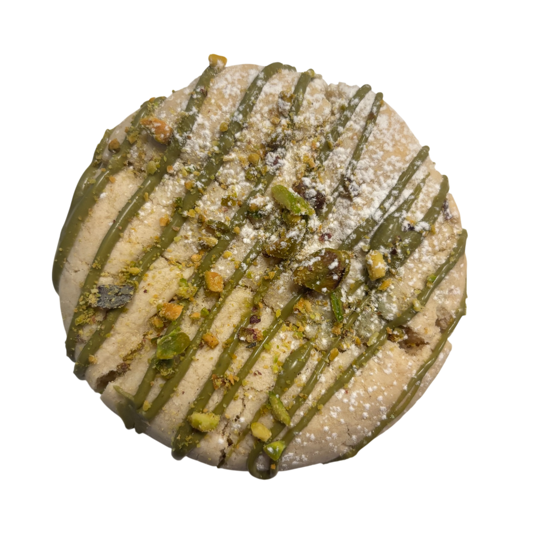 Round cookie with green icing drizzle, chopped pistachios, powdered sugar, and crushed pistachios on top.