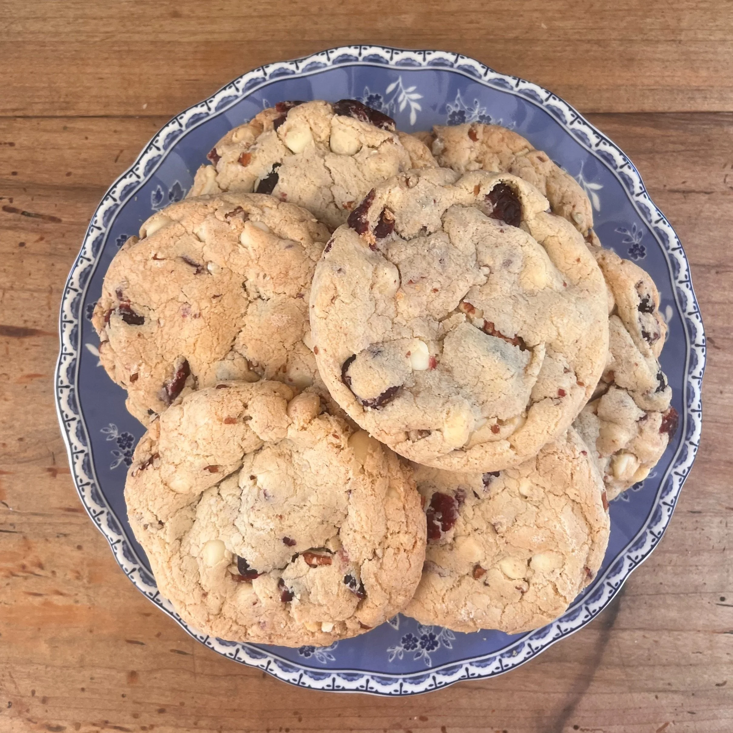 Plate of homemade chocolate chip cookies on a wooden table.