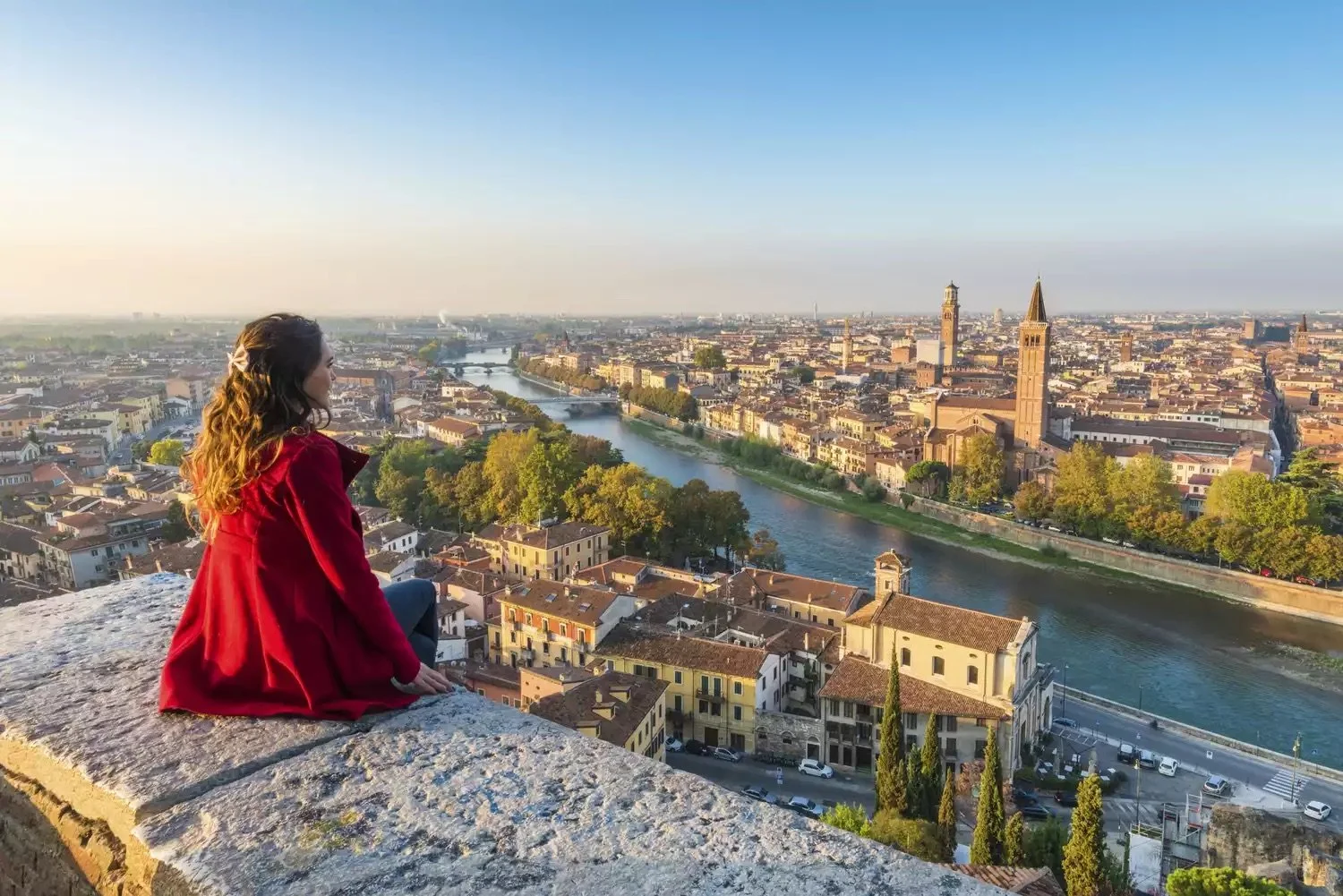 a-young-woman-admires-the-view-of-verona-old-town-from-castel-san-pietro-922096910-5c2fc20246e0fb00017f9af5.jpeg