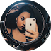 Close-up of a person taking a mirror selfie with a smartphone, reflected in a round mirror.