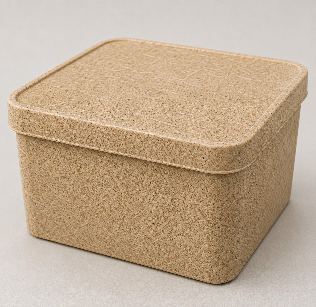 Beige textured square storage box with a lid on a plain background.