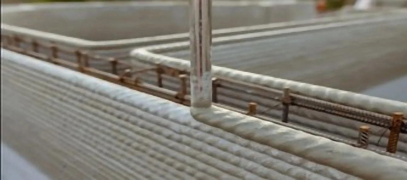 Close-up of an industrial structure with pipes and metal railings.