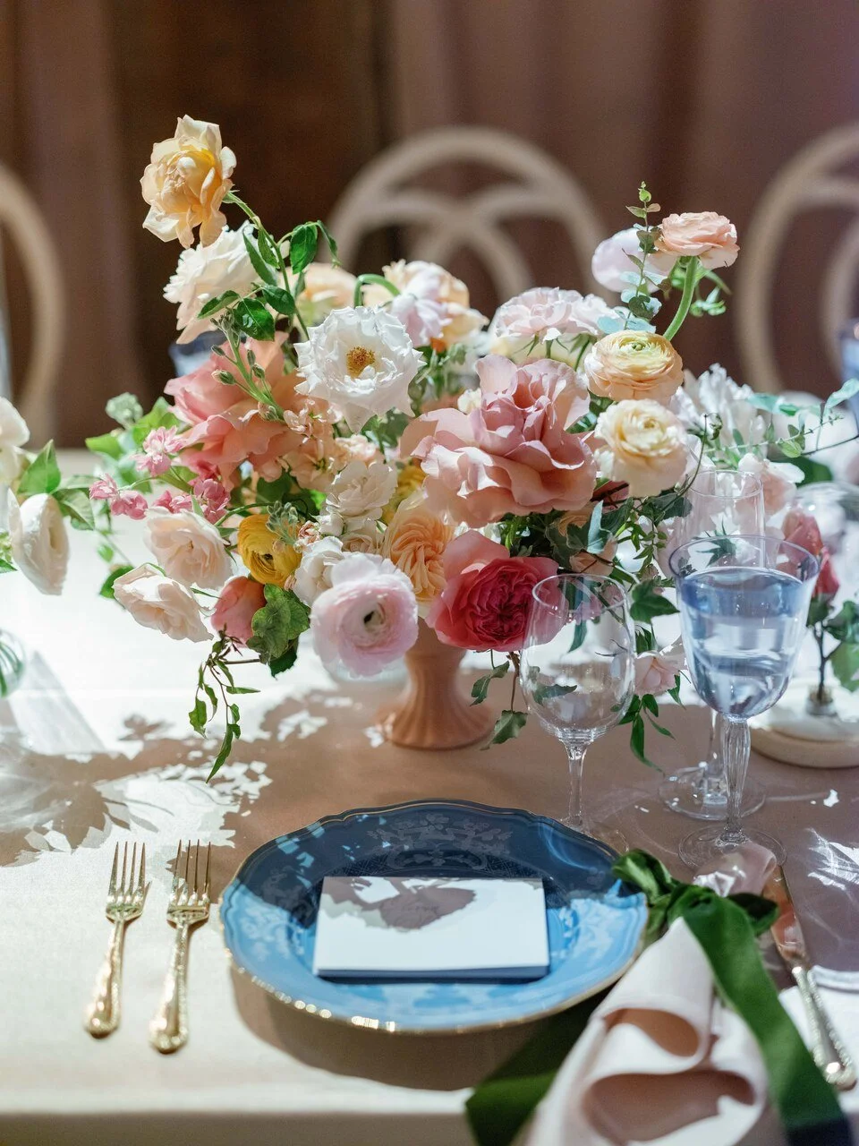tablescape with plates, flatware, florals
