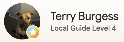 Profile picture of a dog with a yellow coat and dark ears, wearing a black collar, with a computer mouse icon and the label 'Terry Burgess' underneath.