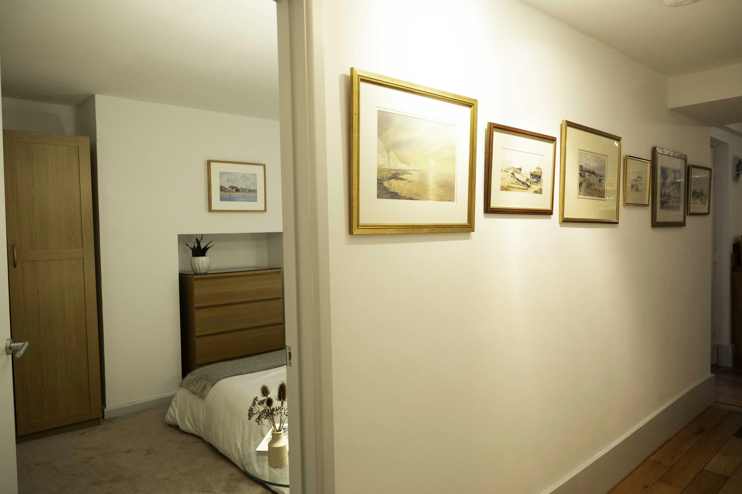 Hallway gallery with original local paintings