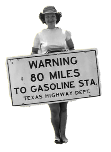 Vintage black-and-white photo of a woman in a summer dress and hat holding a sign that reads, "Warning 80 miles to gasoline sta., Texas Highway Dept."