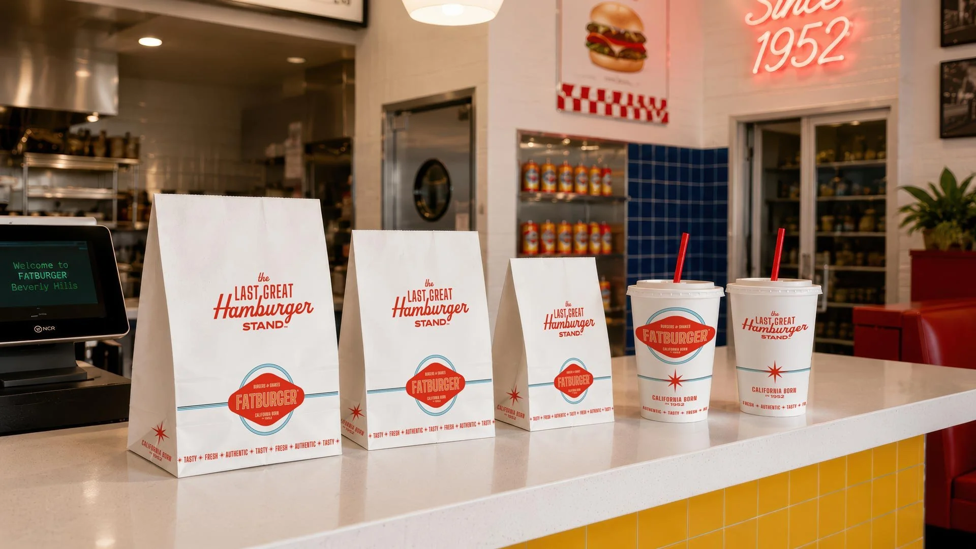 Line of FATBURGER takeout bags and cups, redesigned with new brand identity