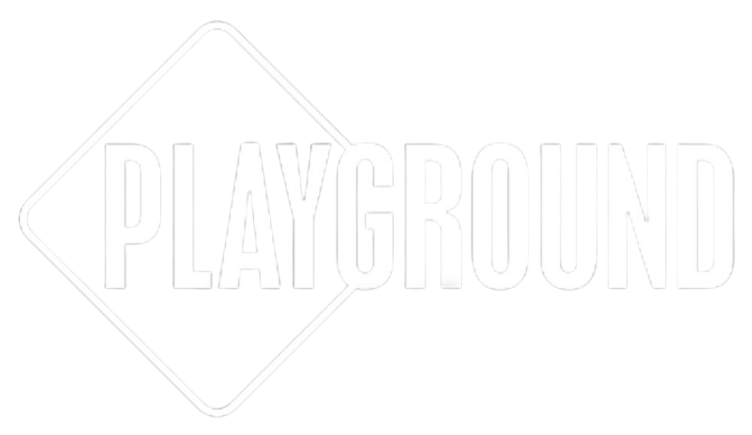 Neon sign reading 'PLAYGROUND' in white letters on a black background.