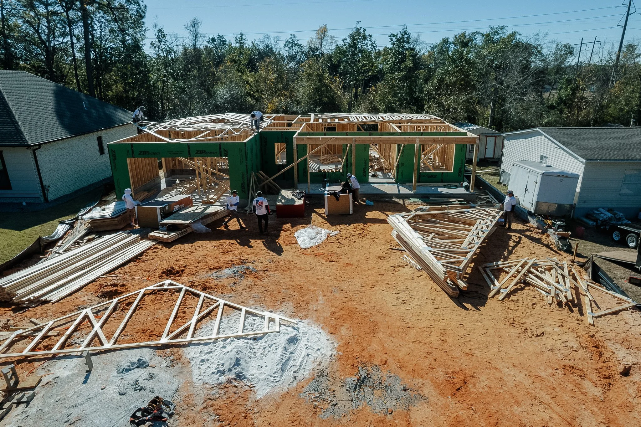 Construction crew building a custom home in Pensacola Florida framing new residential house