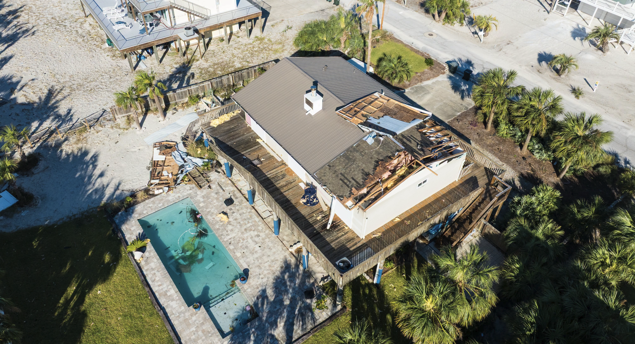 Aerial view of a house on Pensacola Beach that was damaged from Hurricane Isaias