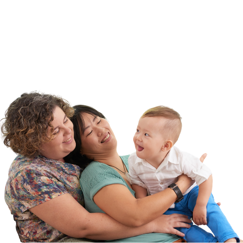 lesbian moms sitting and laughing with toddler son at Adrouny Village Wellness in San Jose California