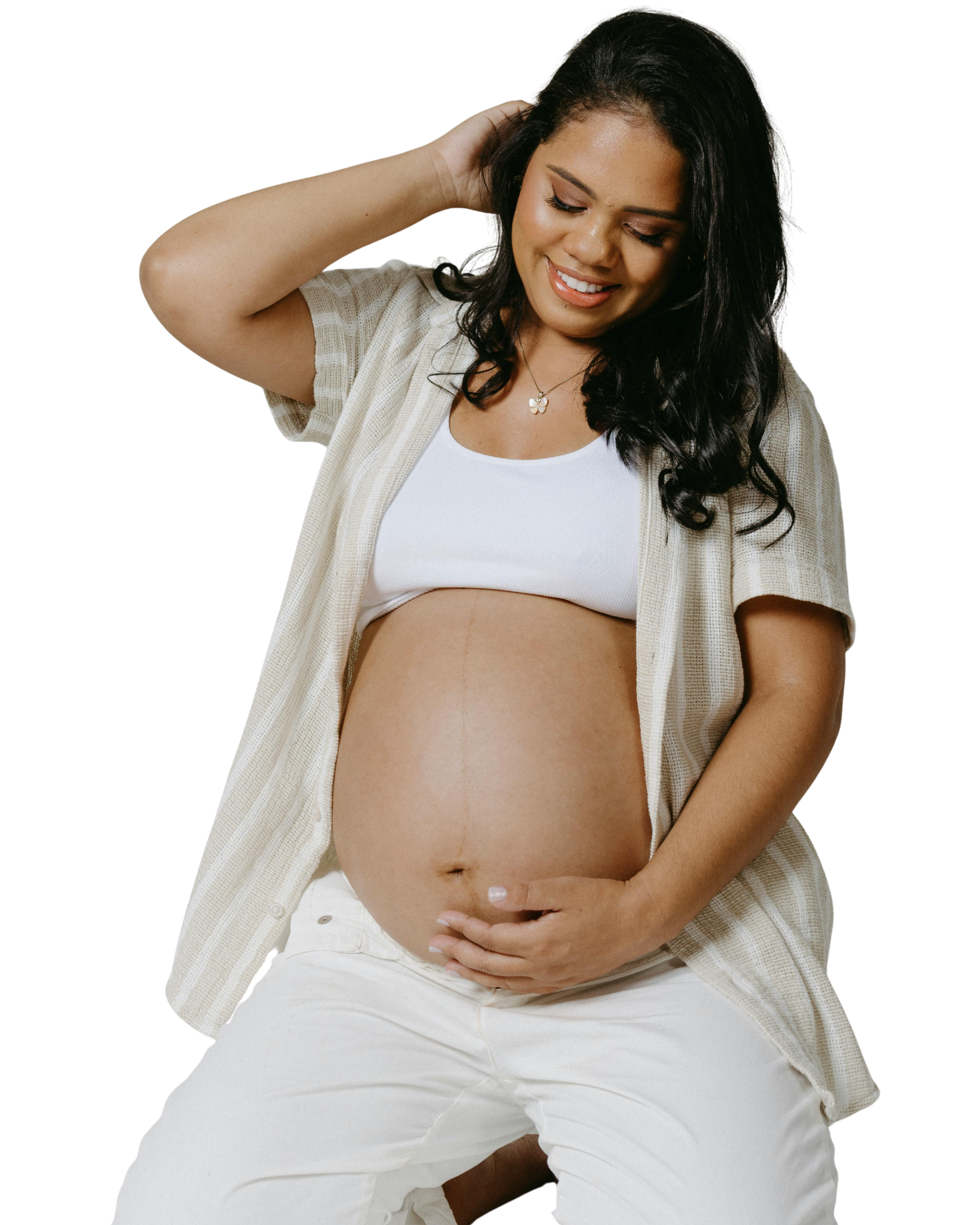 pregnant woman holding belly and smiling adrouny village wellness san jose root to rise prenatal classes in san jose