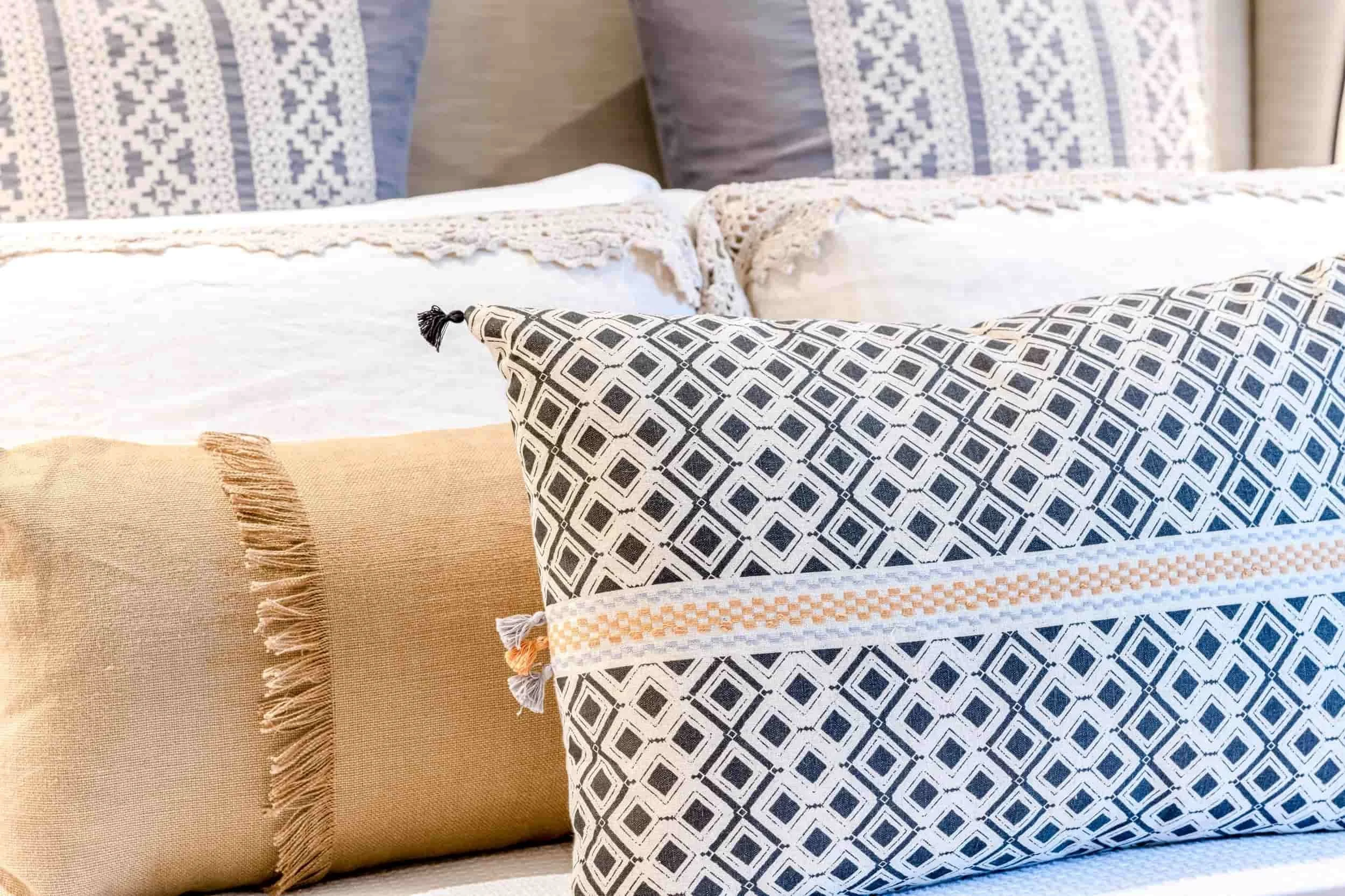 An assortment of custom pillows on a bed