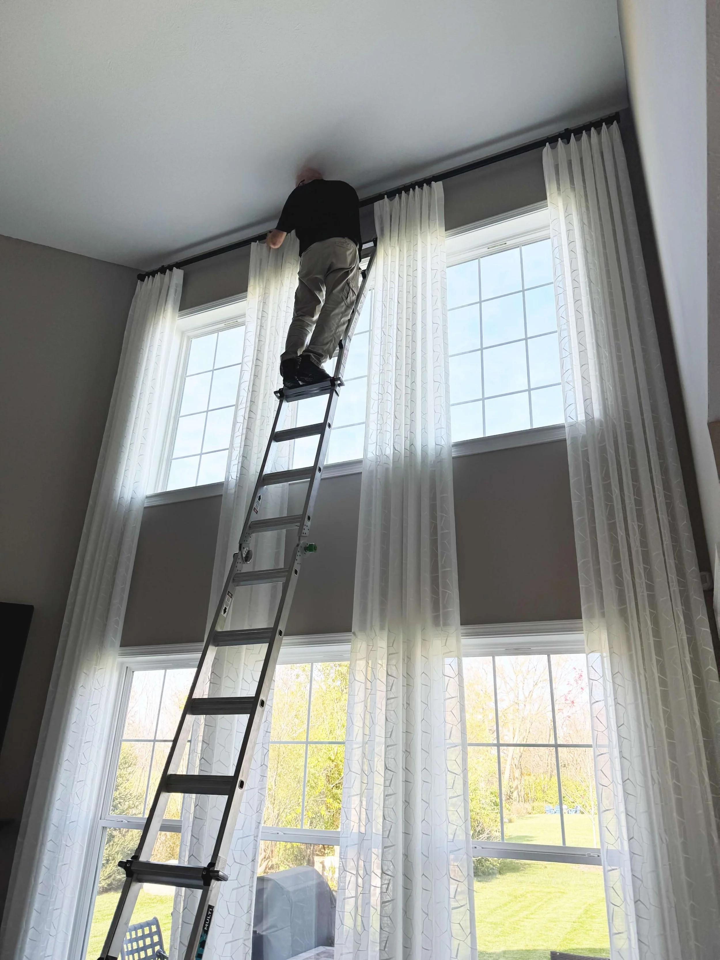 The Pinched Pleat's installer, Thad Smith, installing a client's custom draperies