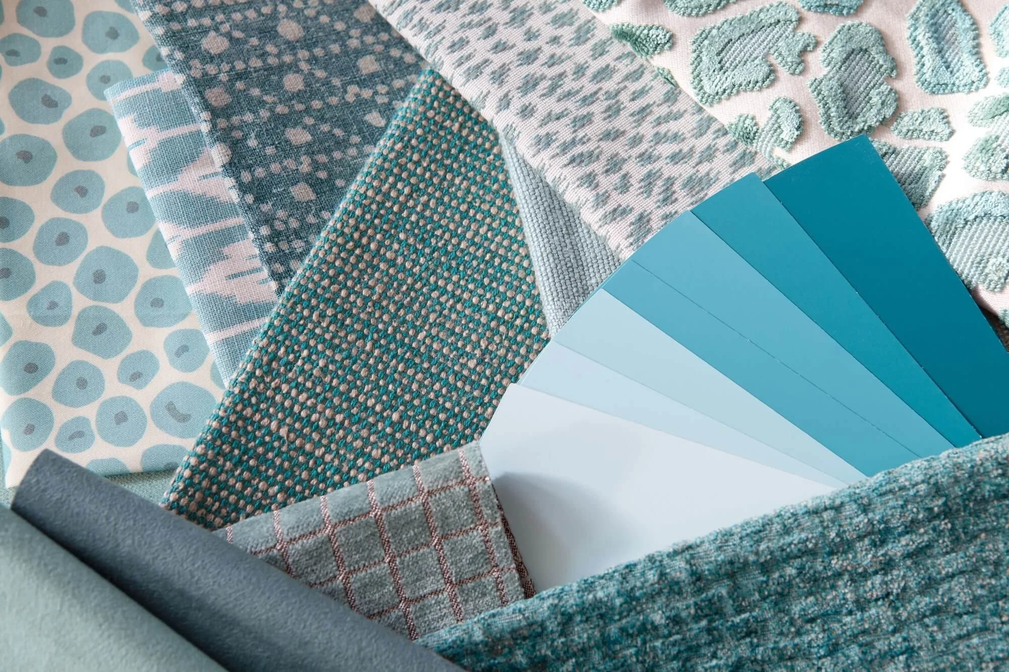 Fabric samples for a client's project in teals and blue-greens