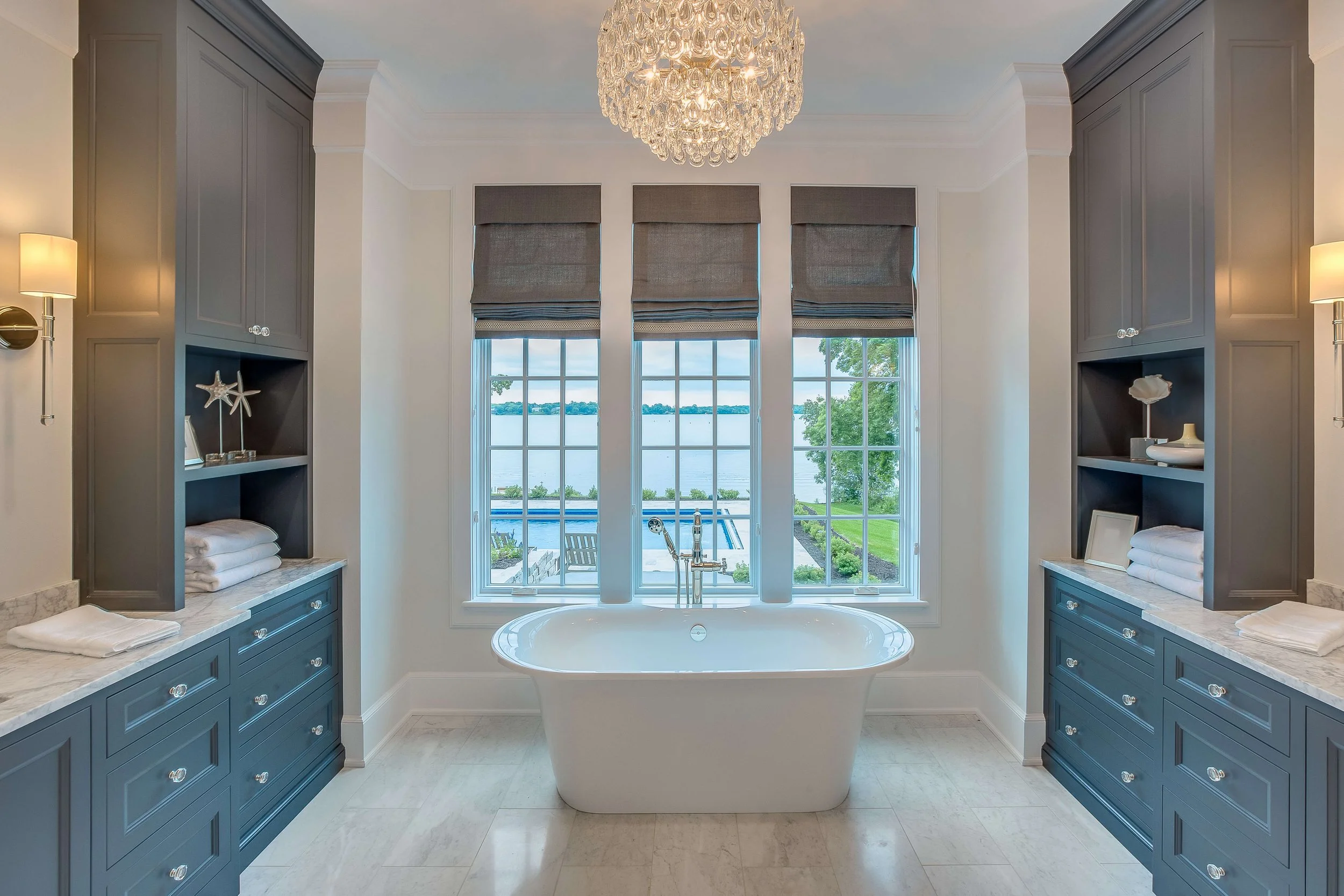 Taupe custom Roman shades with trim at the hem in a primary bathroom