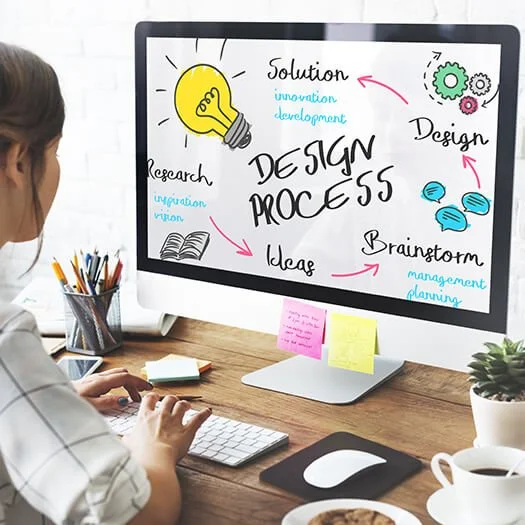 Designer sitting at a computer working on her interior design process