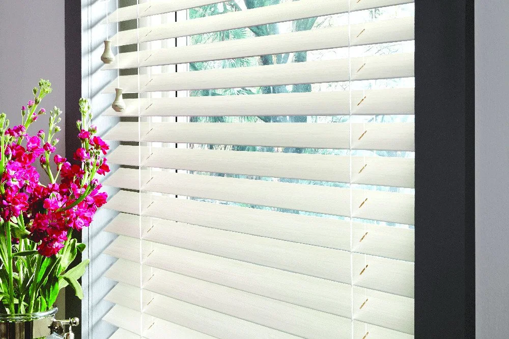 Hunter Douglas white faux wood blinds on a window