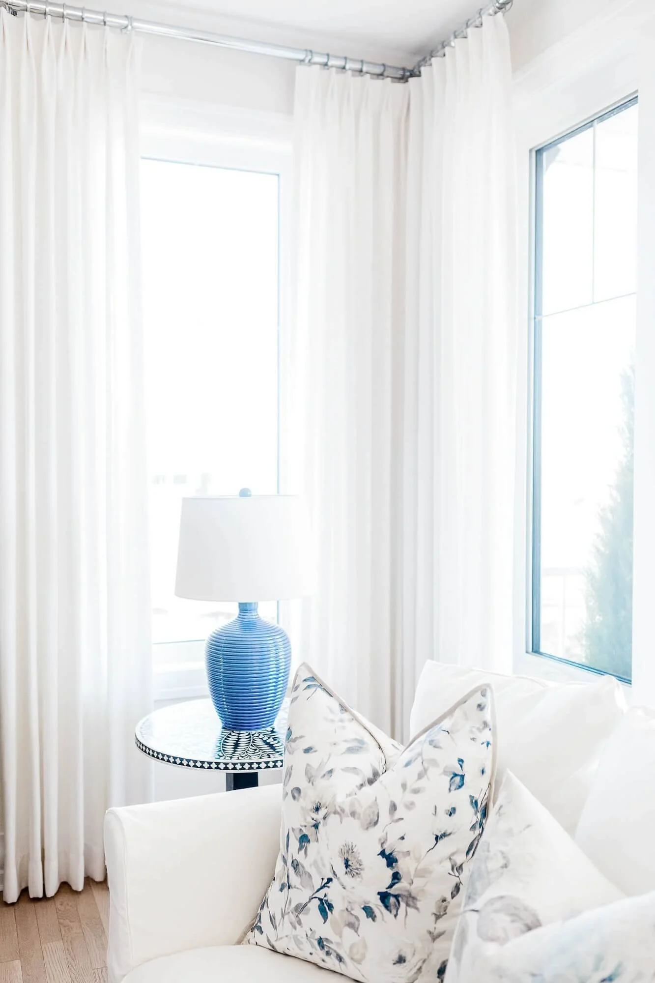 White pinch pleat drapes in a cheery, bright living room