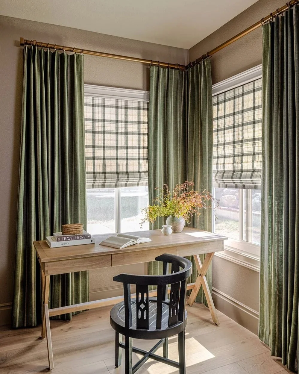 Green drapery panels paired with organic plaid roman shade, installed in an office. Image courtesy of Horizons.