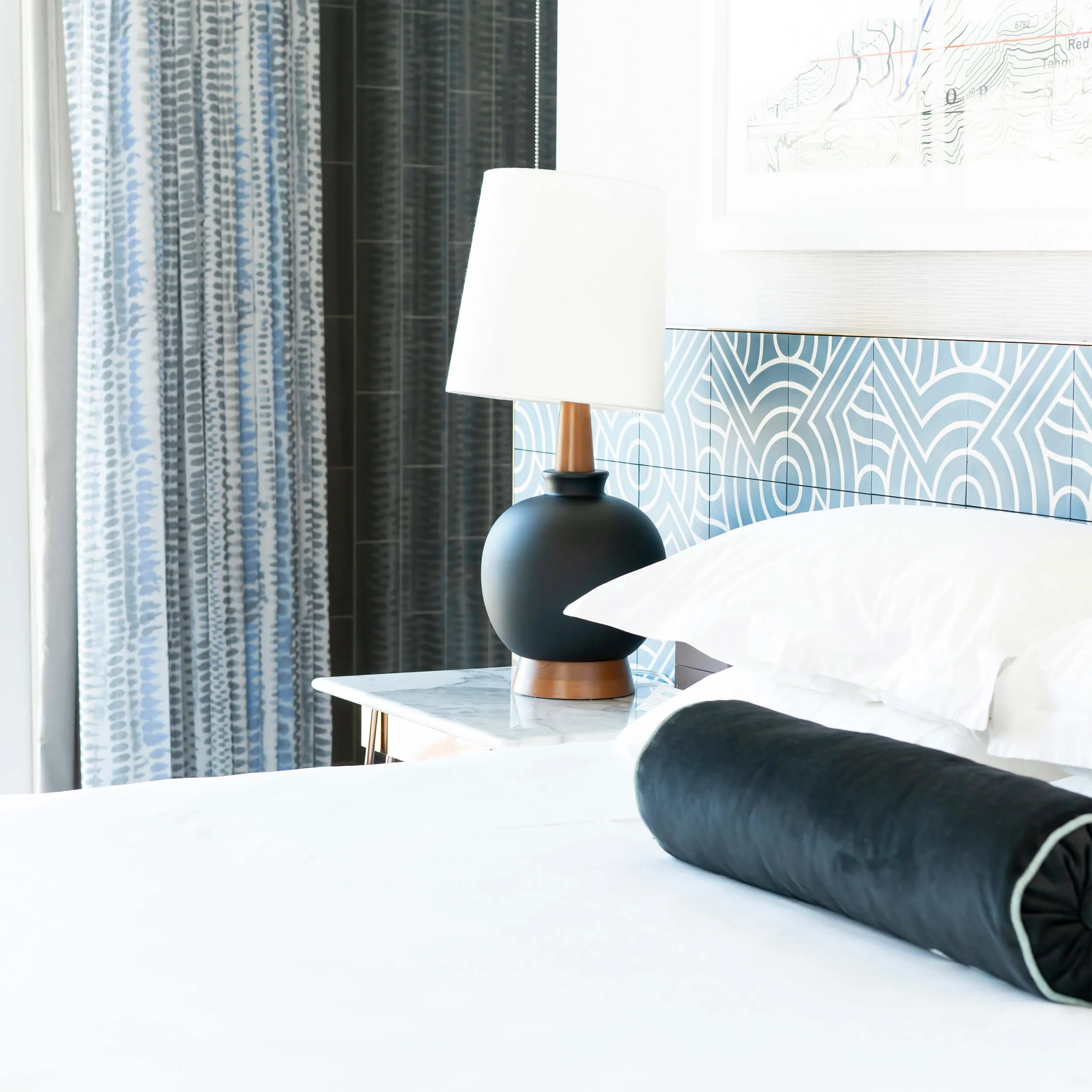 Blue bedding with various, complimentary patterns.