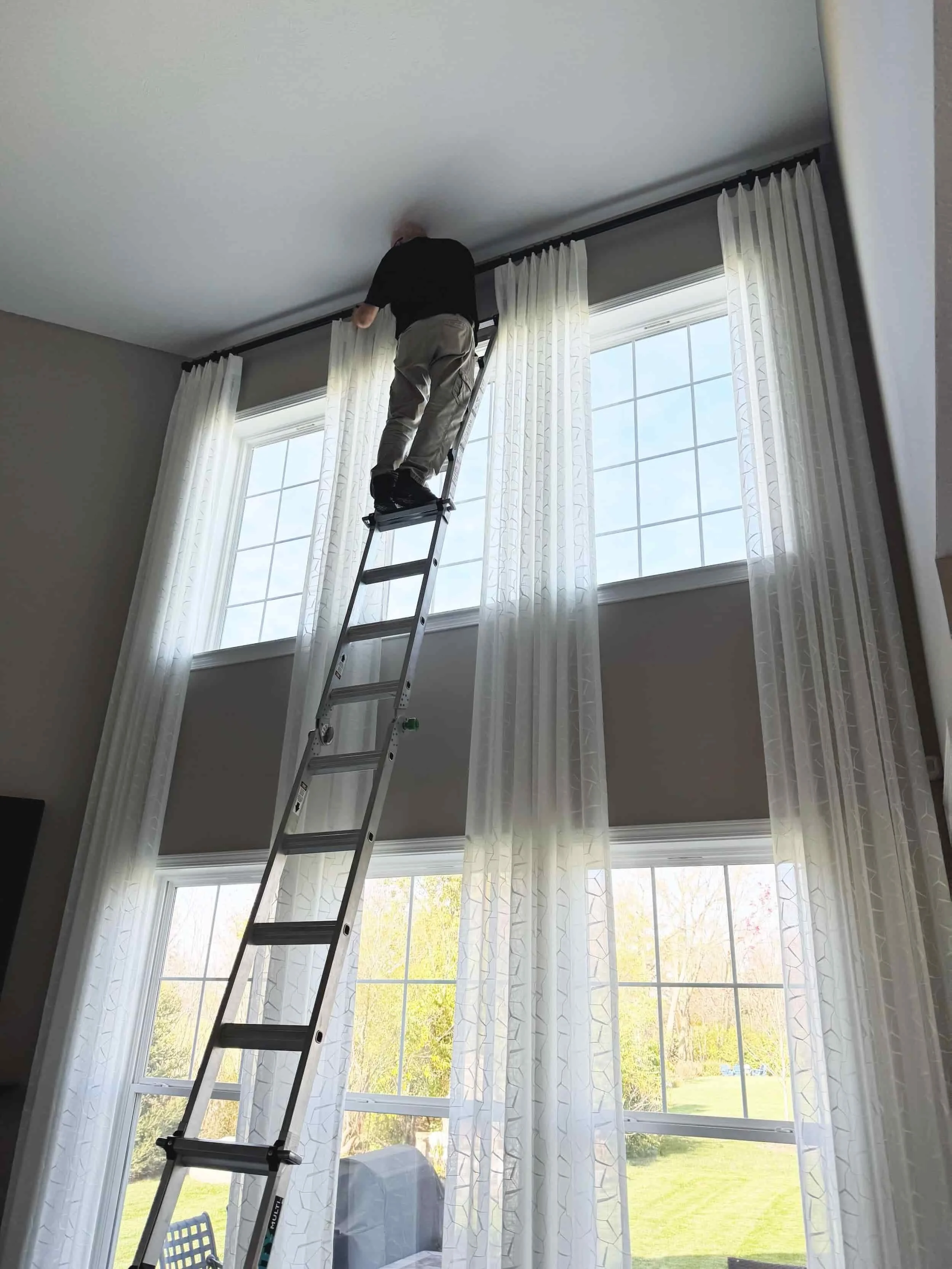 The Pinched Pleat's installer, Thad Smith, installing a client's custom draperies
