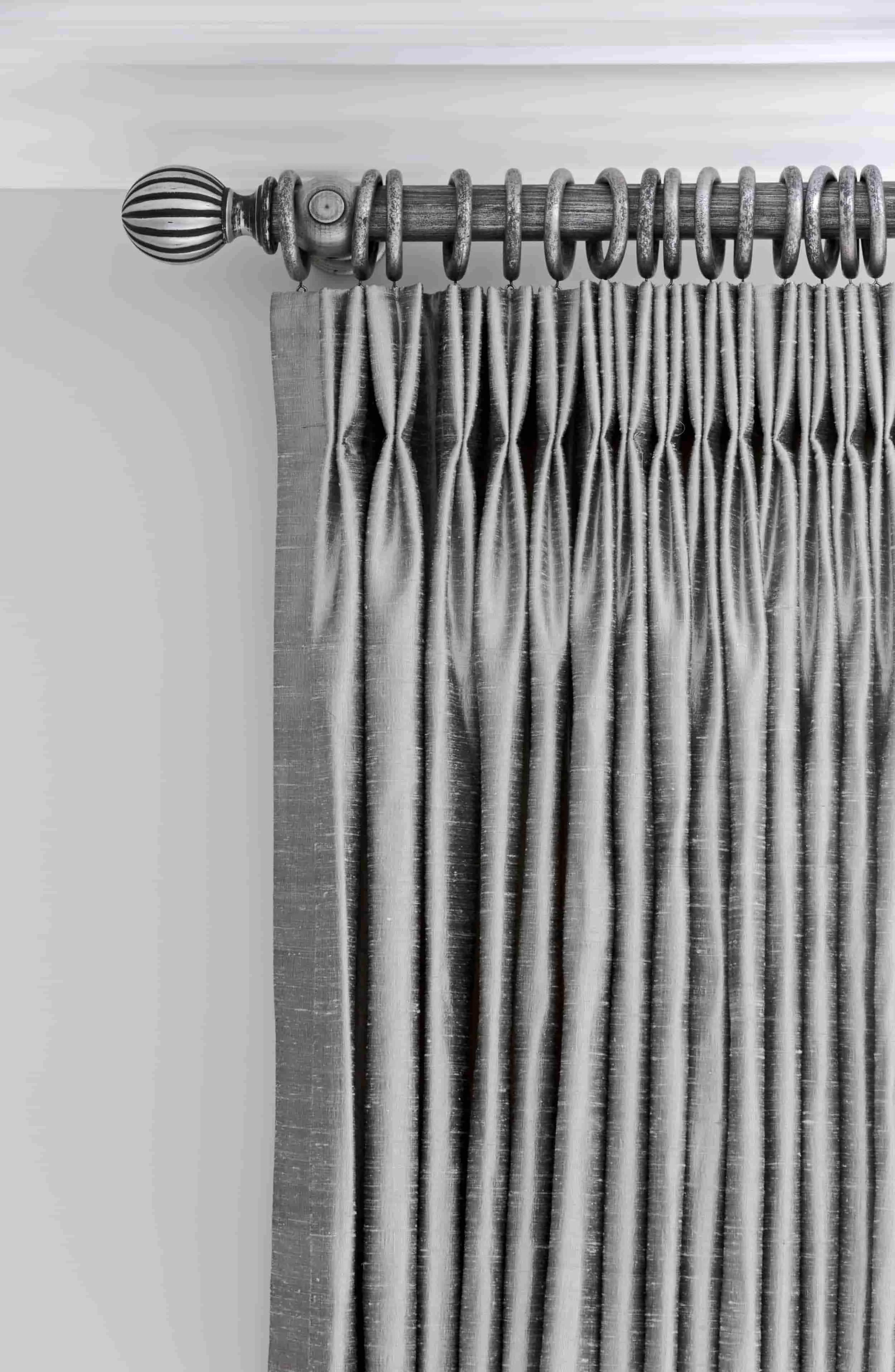 Grey silk pinch pleat draperies on a silver wood custom drapery rod