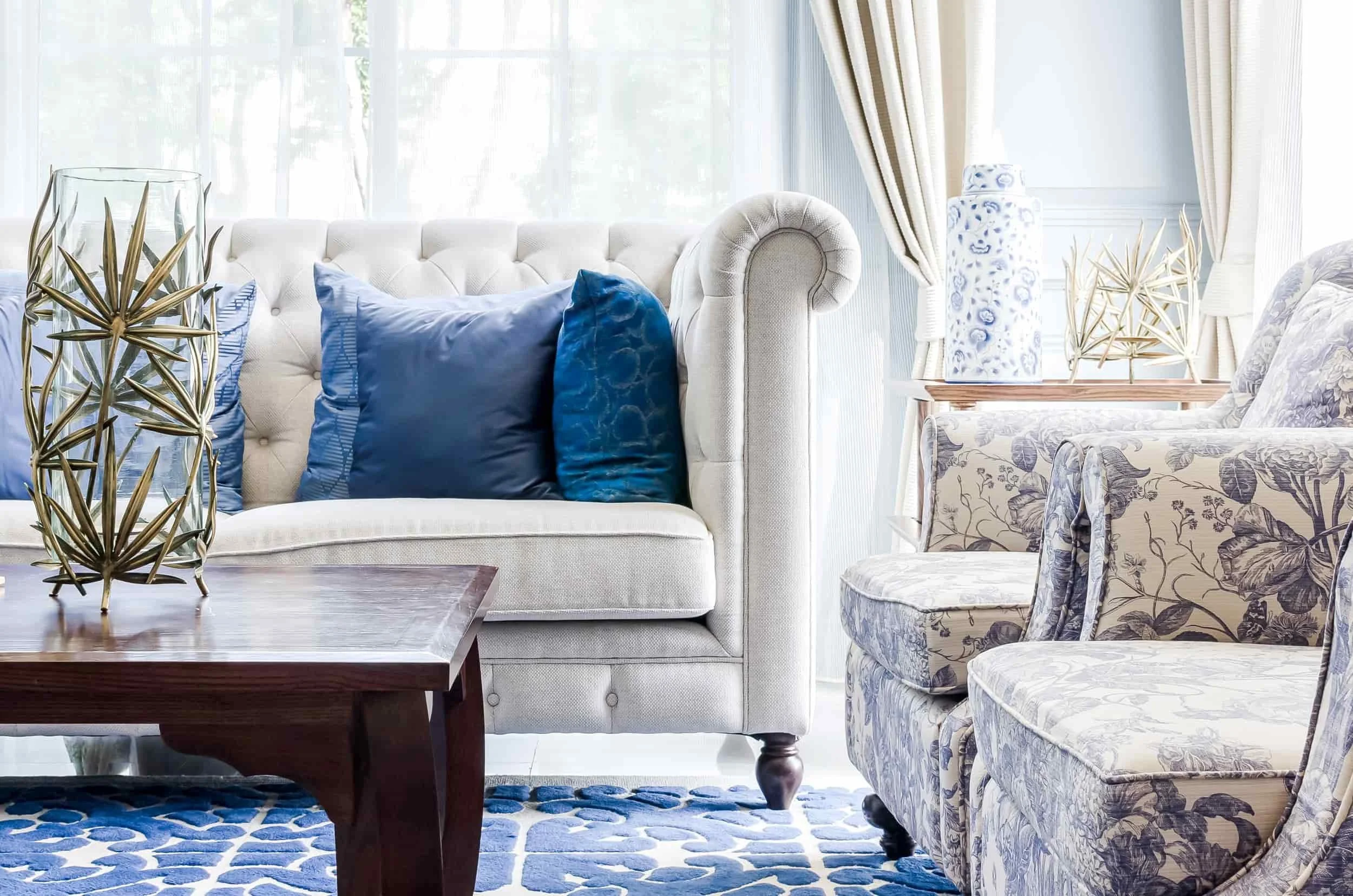 Layered pillows in a blue and white living room