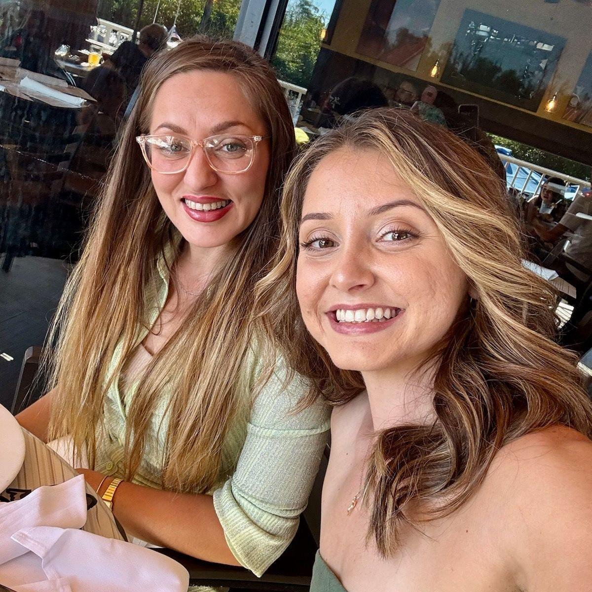 Mia(left)and Mikayla(right) taking a selfie at a restaurant.