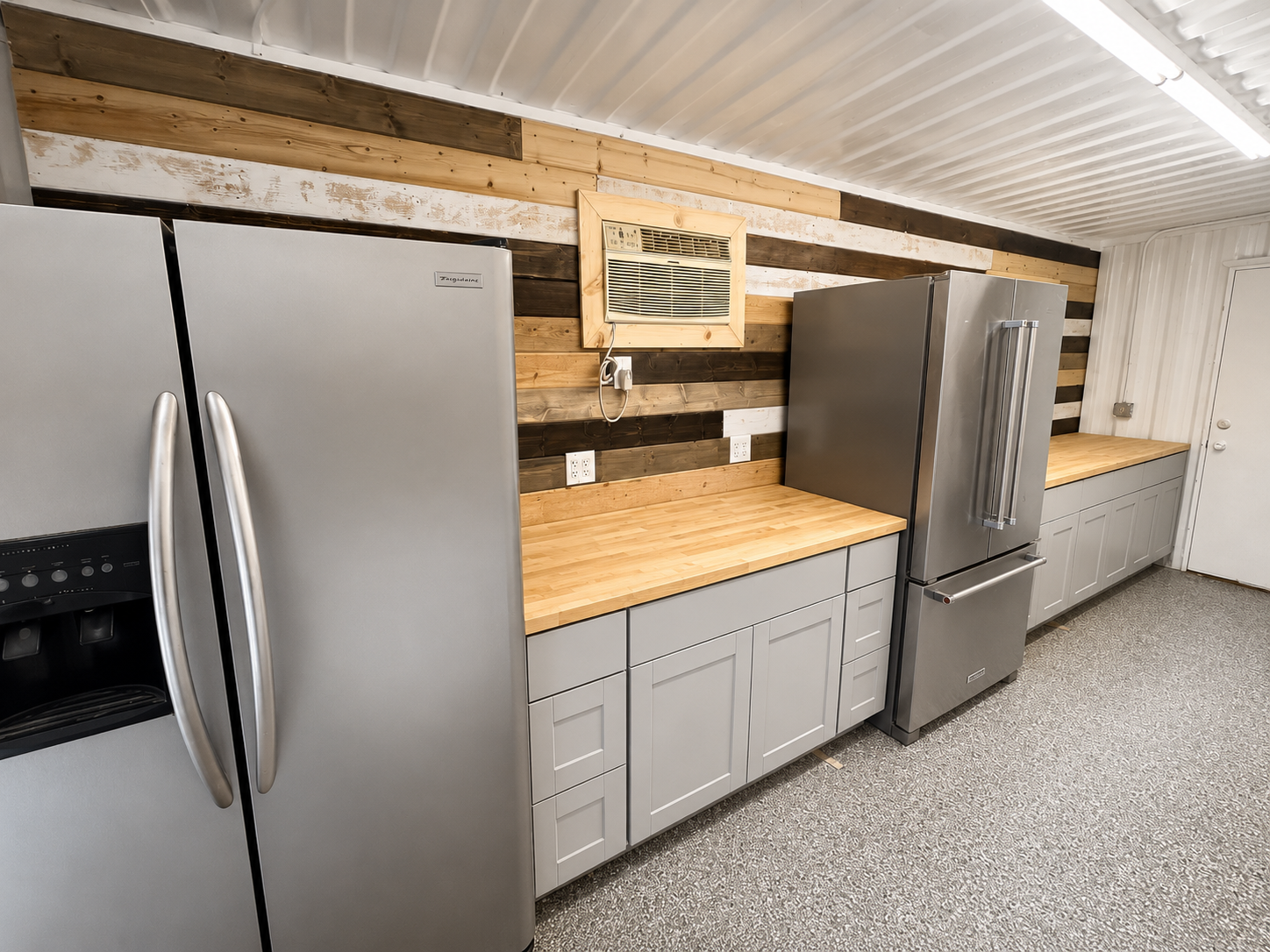 Shipping container snack bar build out, with base cabinets, butcher block countertops, and custom tongue and grove accent wall.