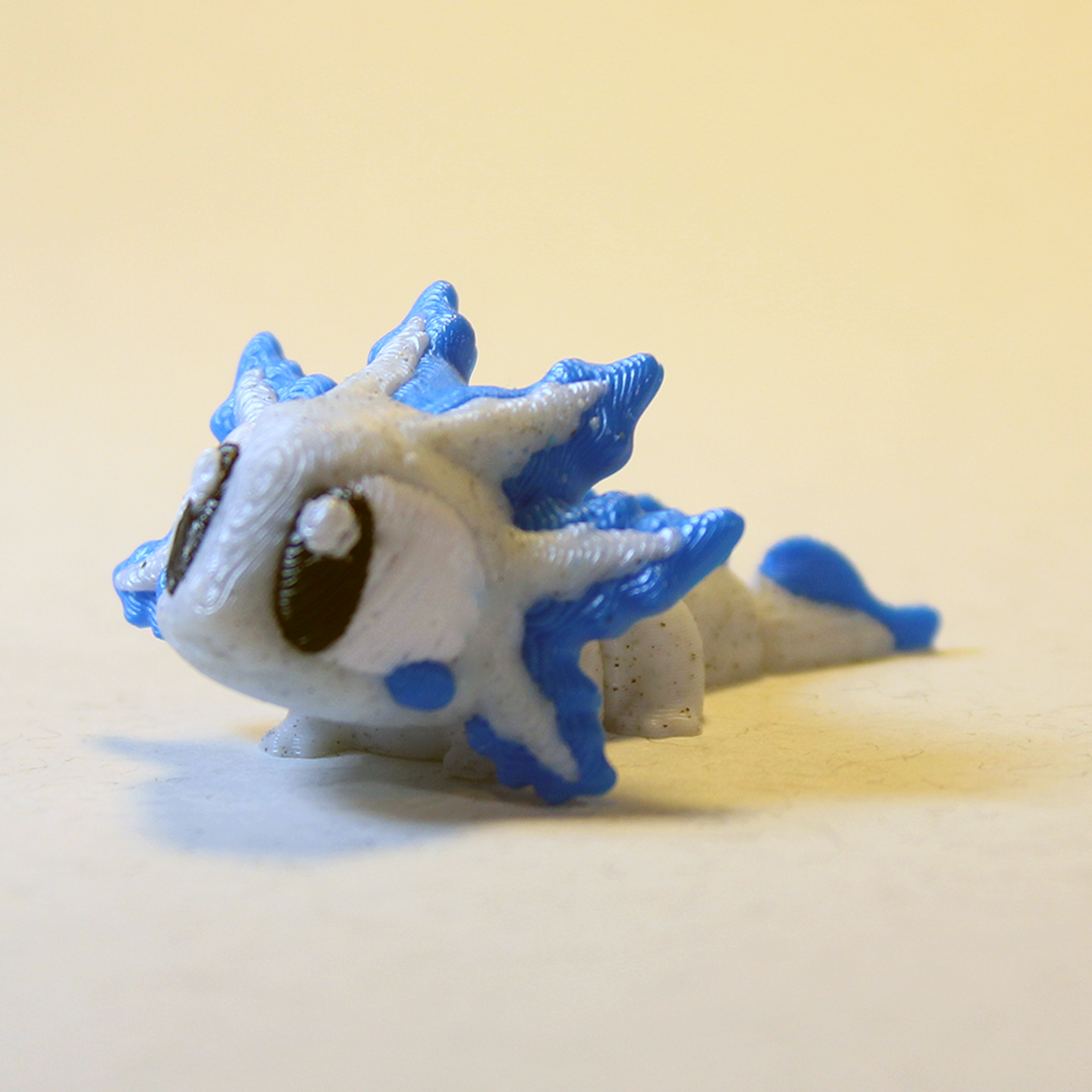 Cute blue and white Zigglie Axolotl toy with big black eyes and frilled fins, perfect collectible gift