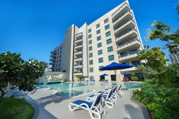 park apartments dubai exterior and pool with lounge chairs
