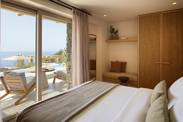 guestroom with view of patio space and sea view from sliding glass door