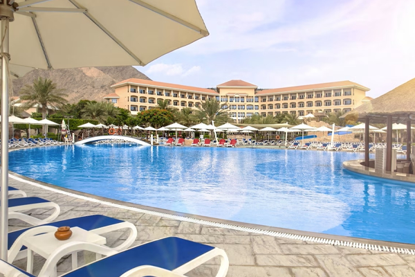 pool at fujairah rotana resort and spa with hotel exterior in the background