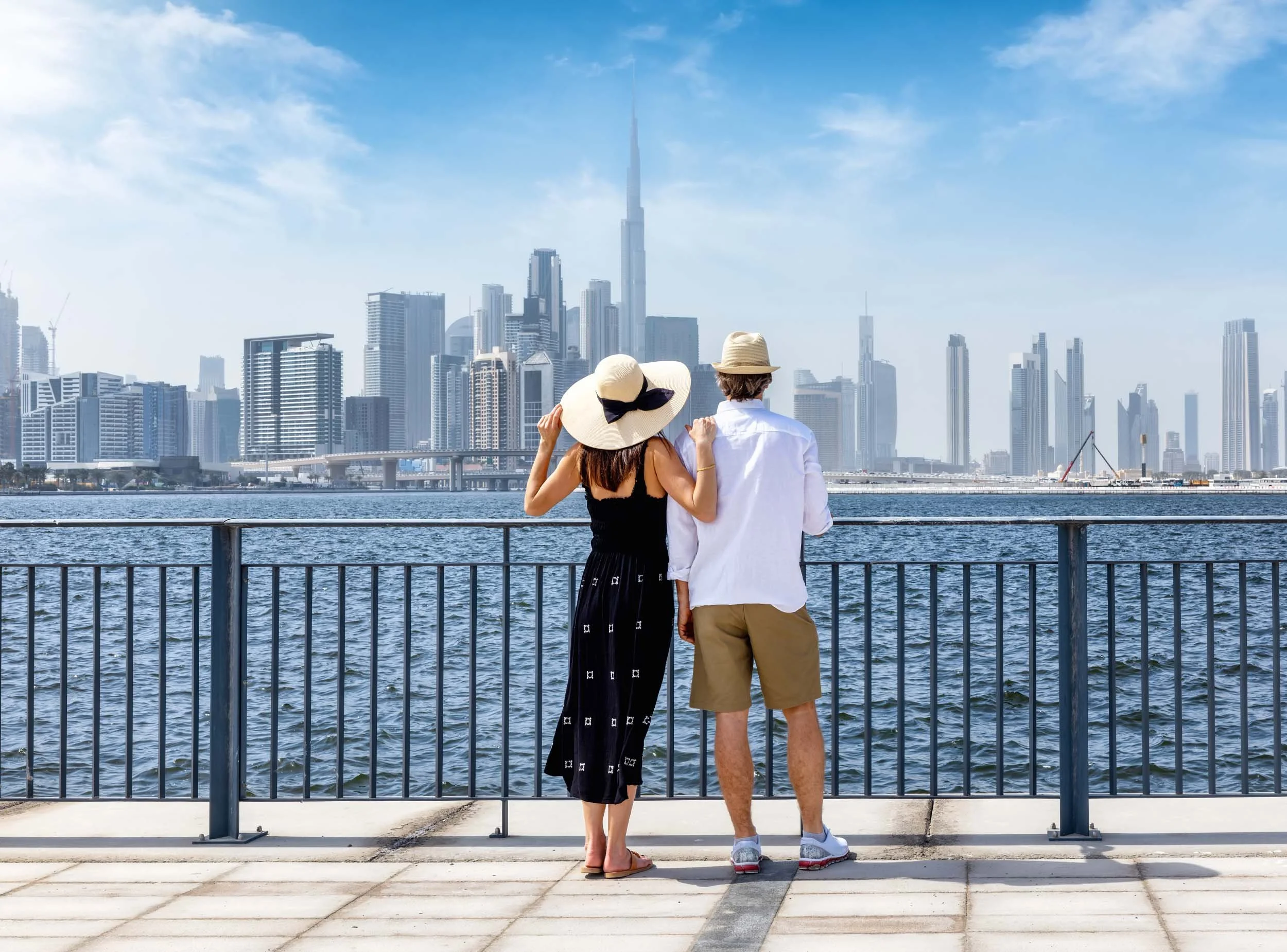 couple looking over water and dubai skyline